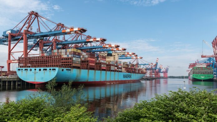 Photo by Wolfgang Weiser a large blue boat sitting next to a dock