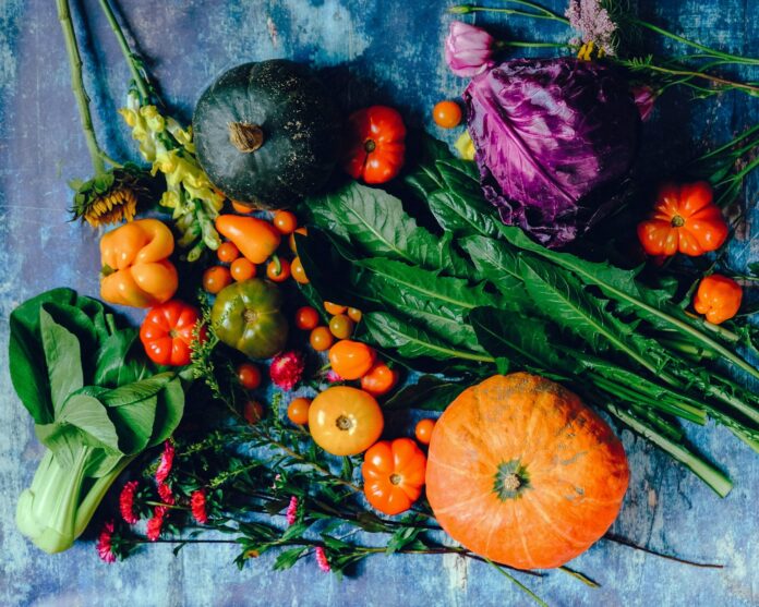 Photo by Ella Olsson vegies on blue surface