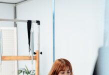 30~40대가 관심가지는 필라테스로 건강관리 하는 법 a woman on a rowing machine in a gym