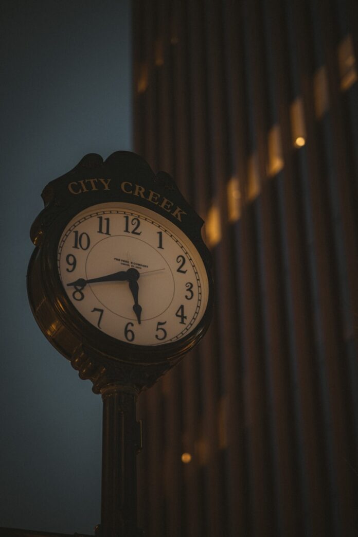 a clock on a pole in front of a building