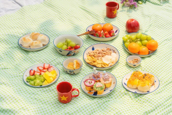 Photo by Cuong Duyen Ceramics A picnic spread with various fruits and pastries.