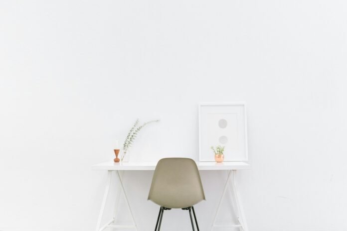 Photo by Bench Accounting white wooden table near brown chair