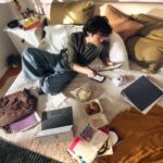집에서도 실천하는 ‘슬로우 라이프’, 작은 변화가 건강을 바꾼다 Young man on bed with laptop and snacks